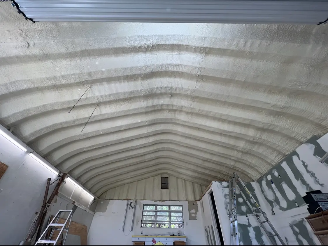 Spray polyurethane foam applied to the underside of a metal roof deck in Sugar Land